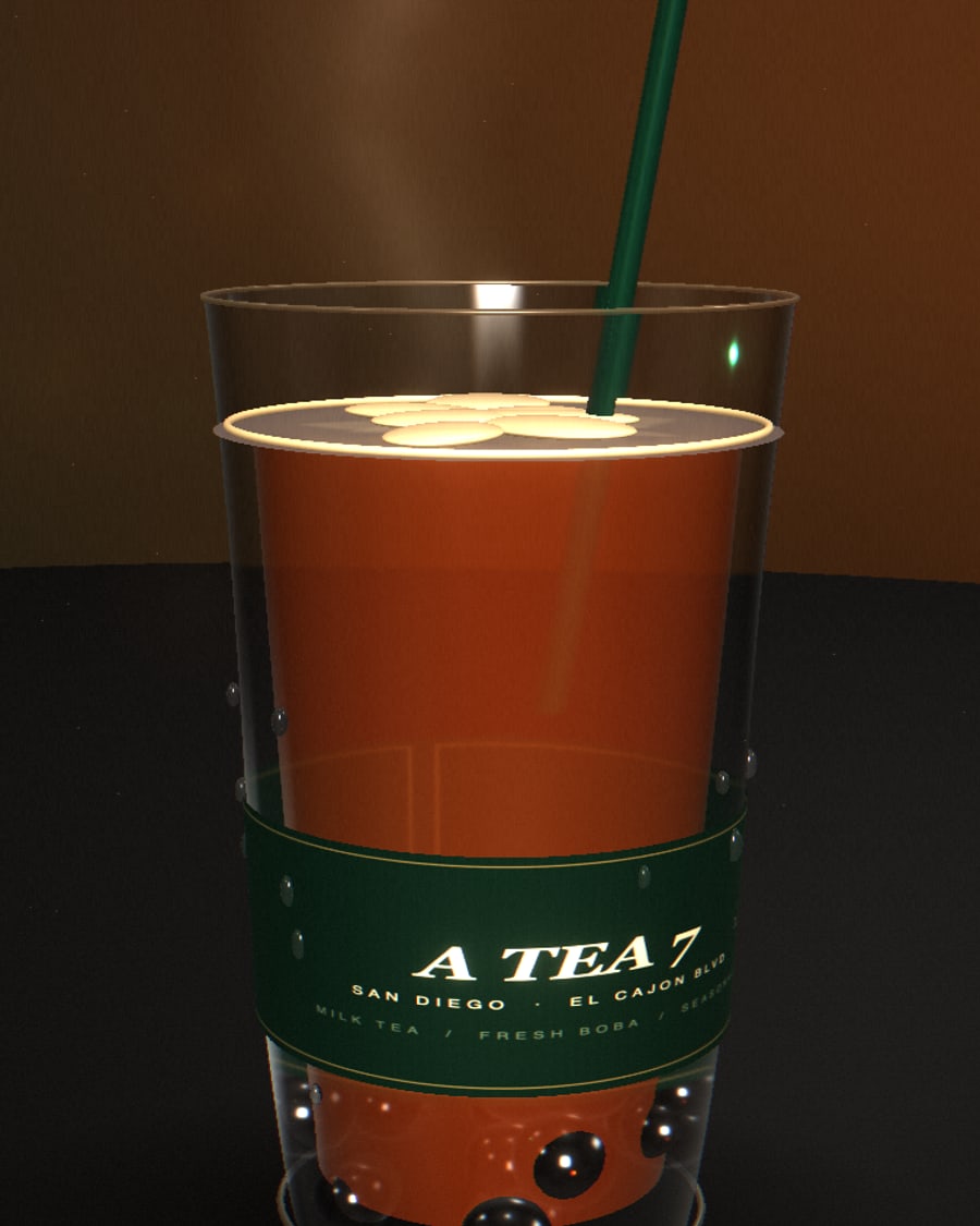 A TEA 7 amber milk tea in a glass cup with fresh boba pearls